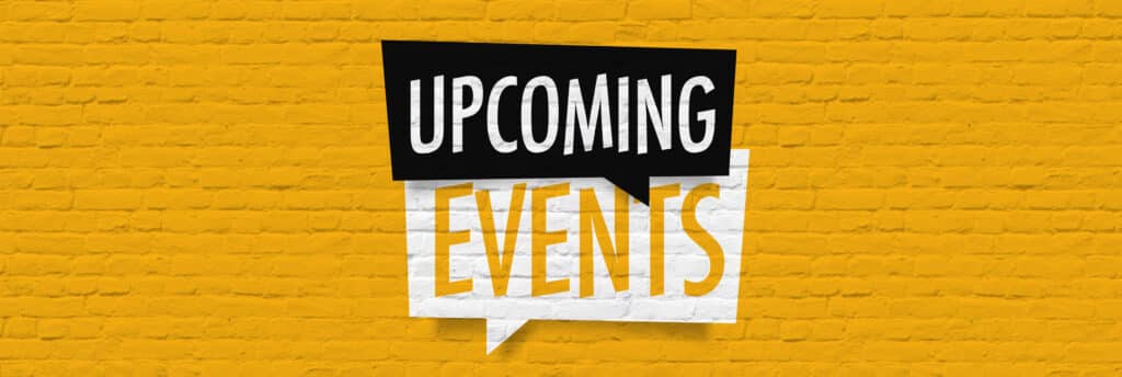 Upcoming Events sign painted in black and white on yellow brick wall