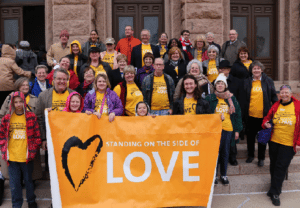 Unitarian Universalists wearing Side with Love tshirts in front of the Texas capital